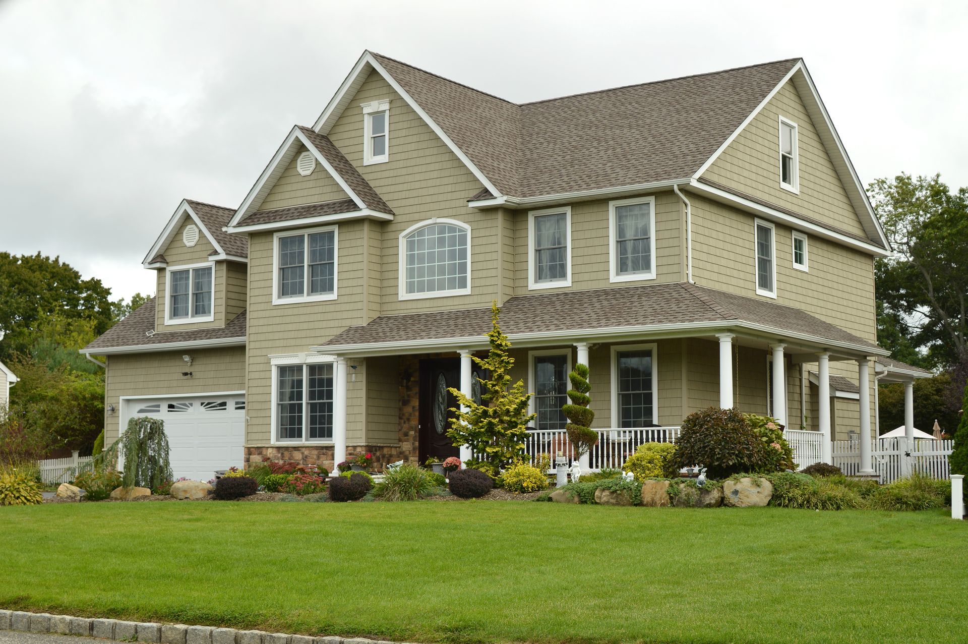 Two-story beige house with white trim