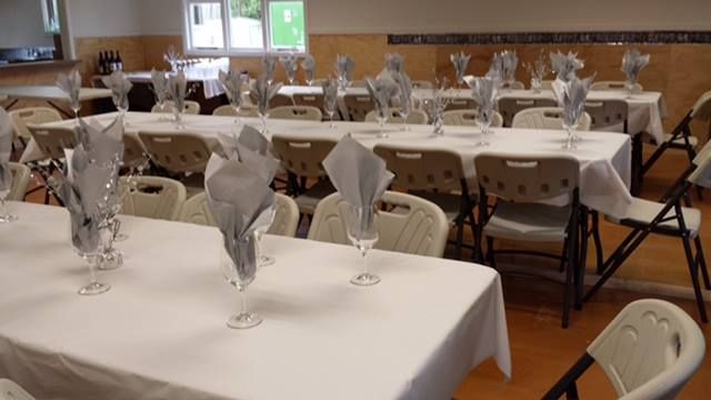 A room with tables and chairs set up for a party