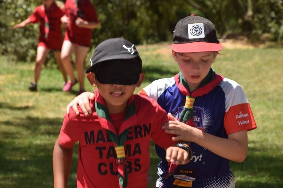 A group of children are running through a river.