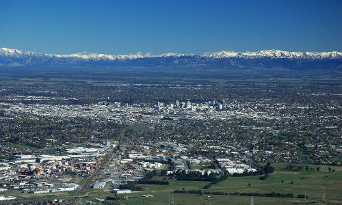 An aerial view of a city with mountains in the background