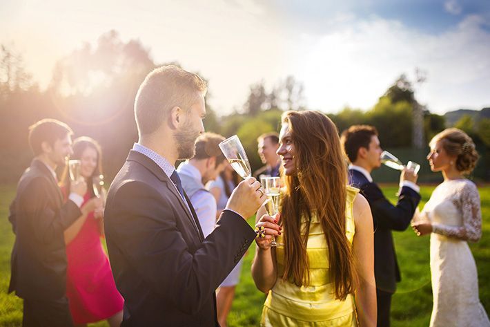 A group of people are drinking champagne at a wedding reception.