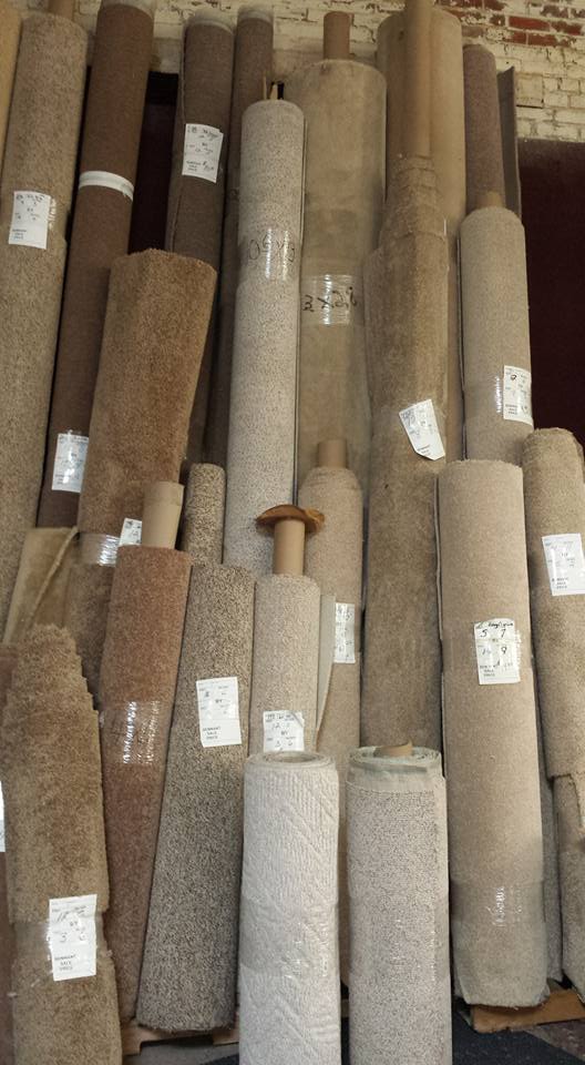 A bunch of rolls of carpet are stacked on top of each other