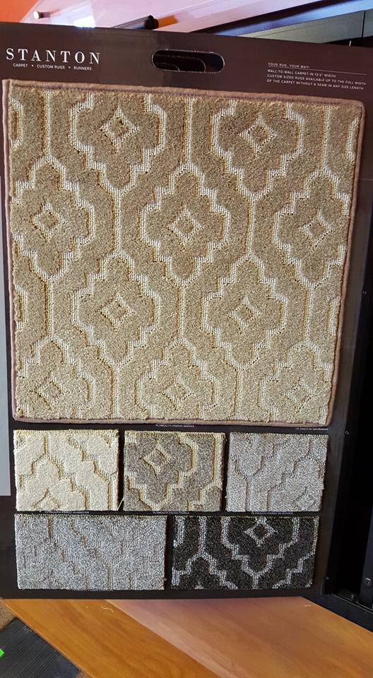 A carpet swatch is sitting on top of a wooden table.