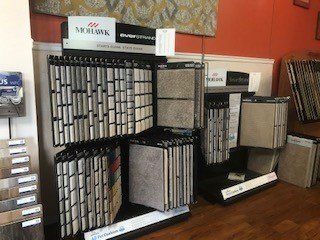 A display of carpets and tiles in a store.