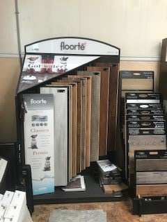 A display case filled with wooden flooring samples in a store.