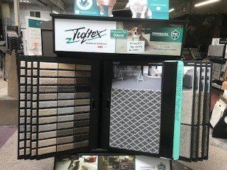 A display of carpets and tiles in a store.