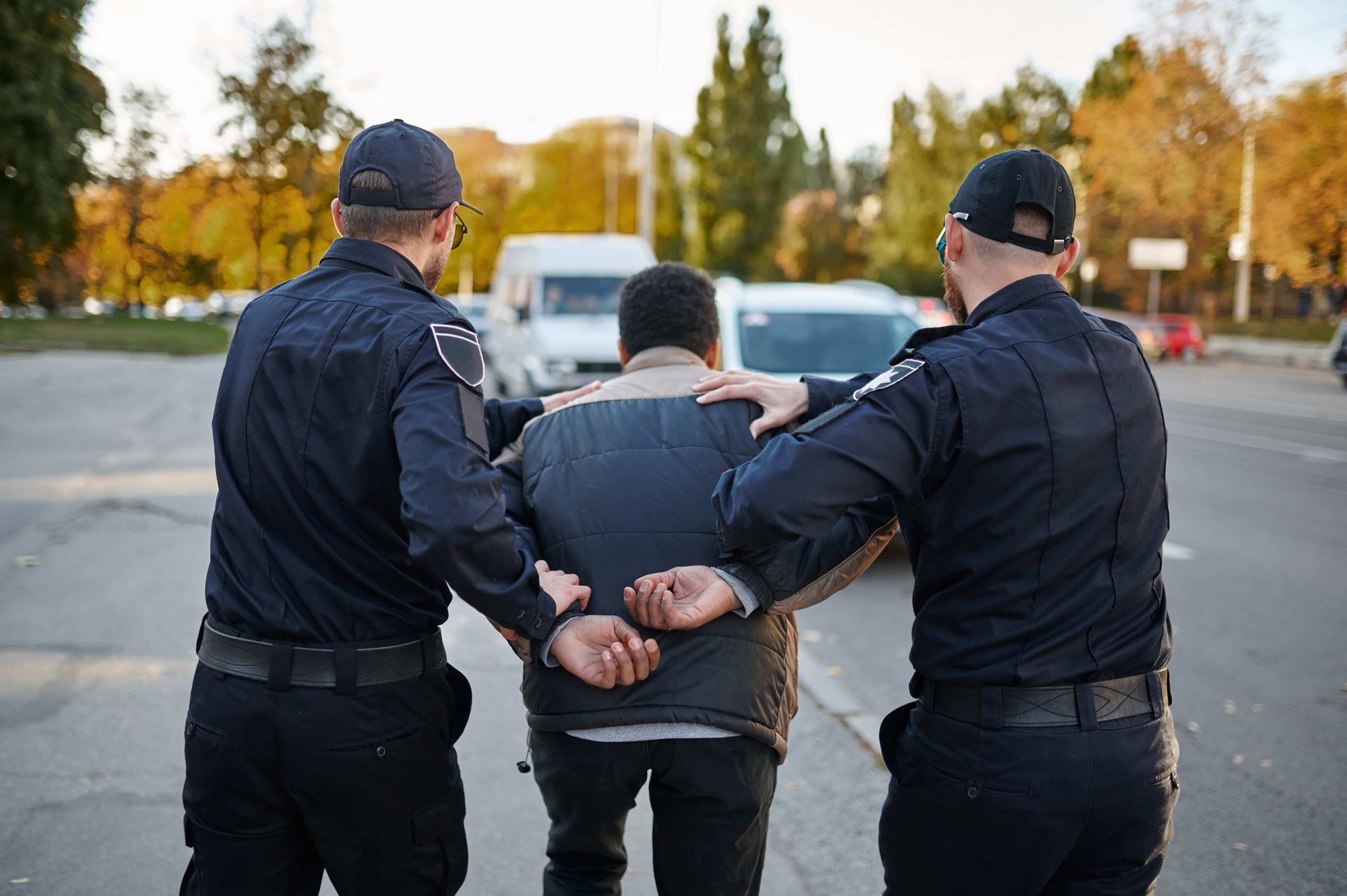 a man arrested by two police