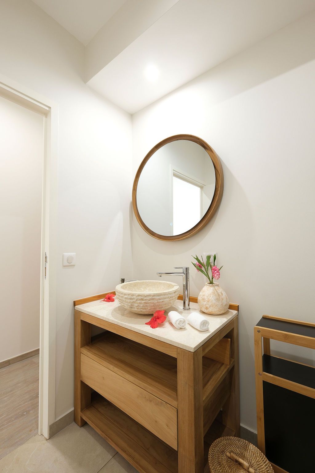 A bathroom with a sink and a mirror on the wall.