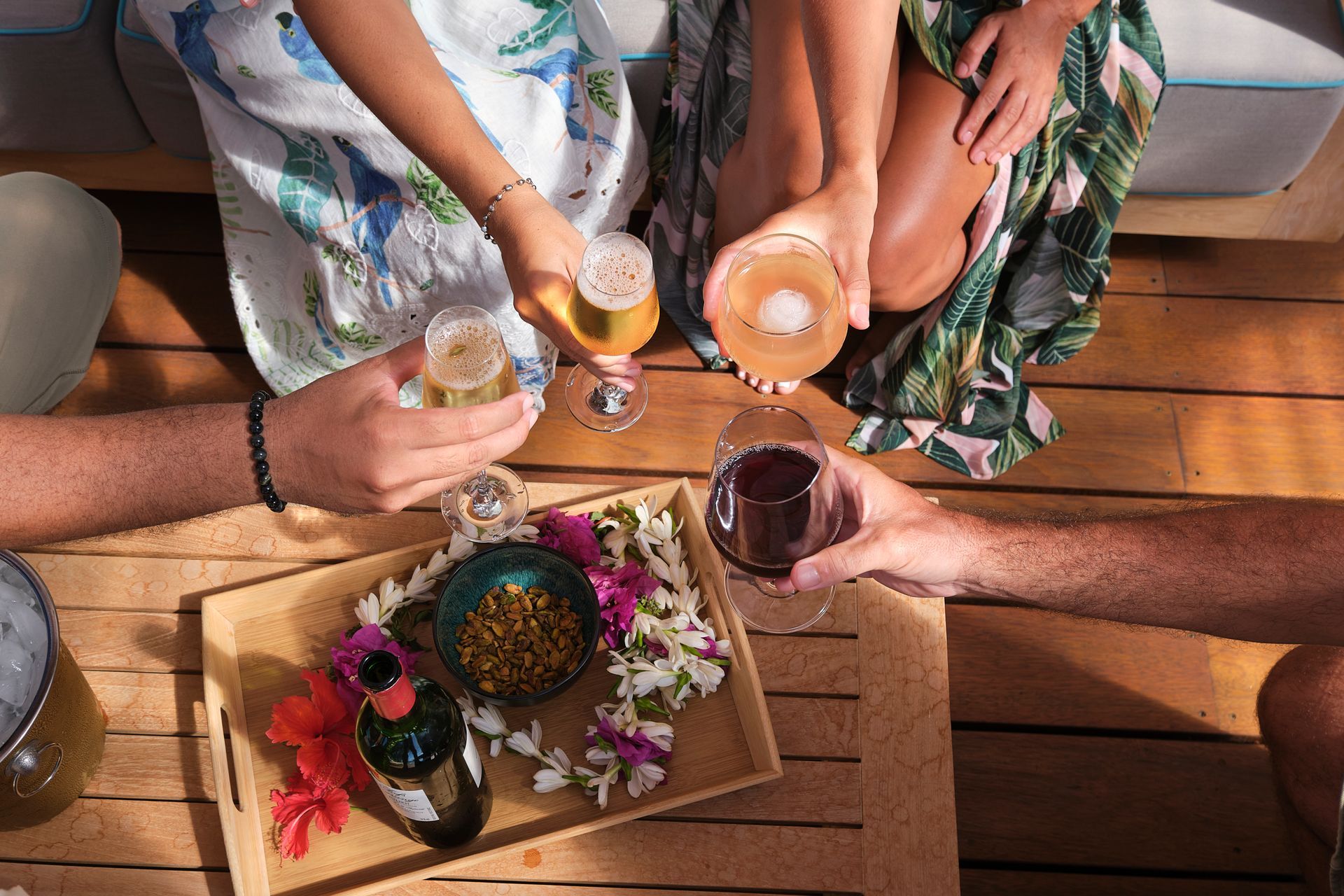 A group of people are sitting at a table toasting with wine glasses.
