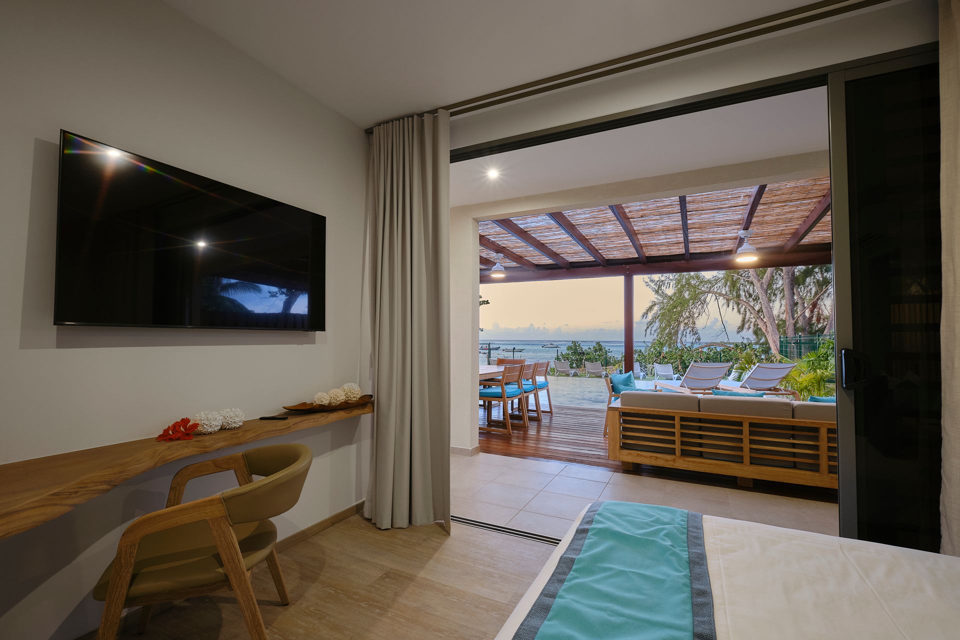 There is a large flat screen tv on the wall above the bed.