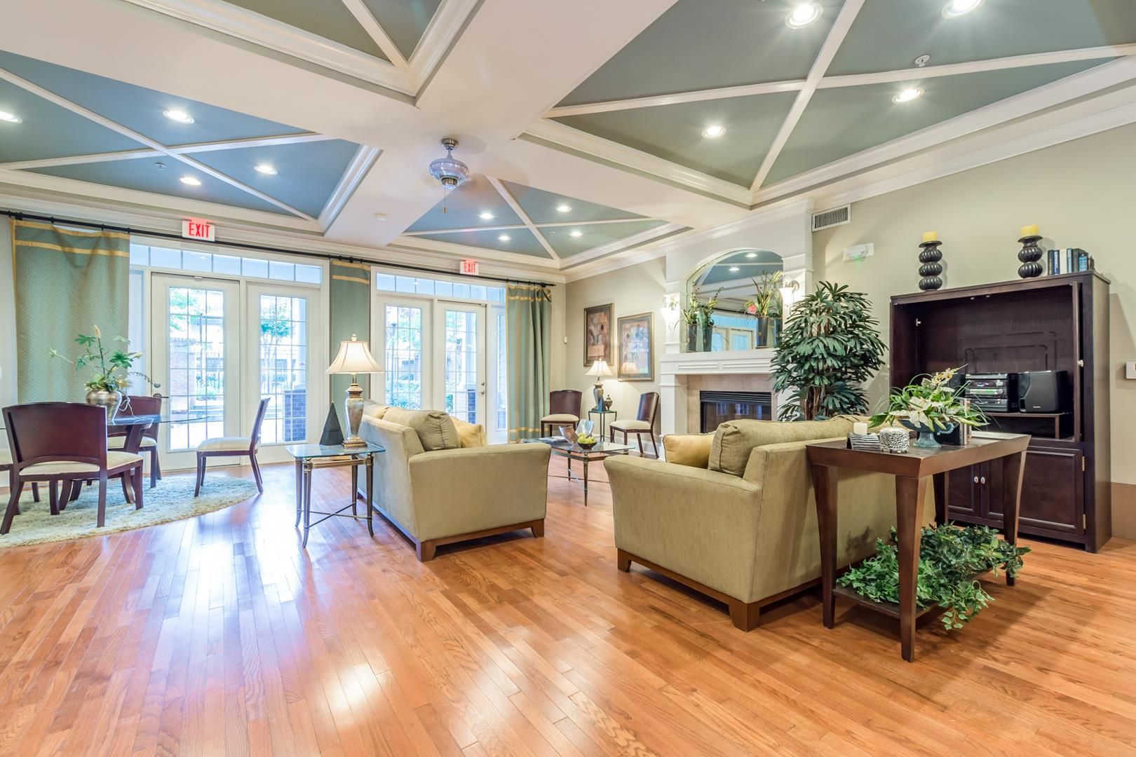 Ranch-style house with brick and gray accents, front porch, and lush landscaping.