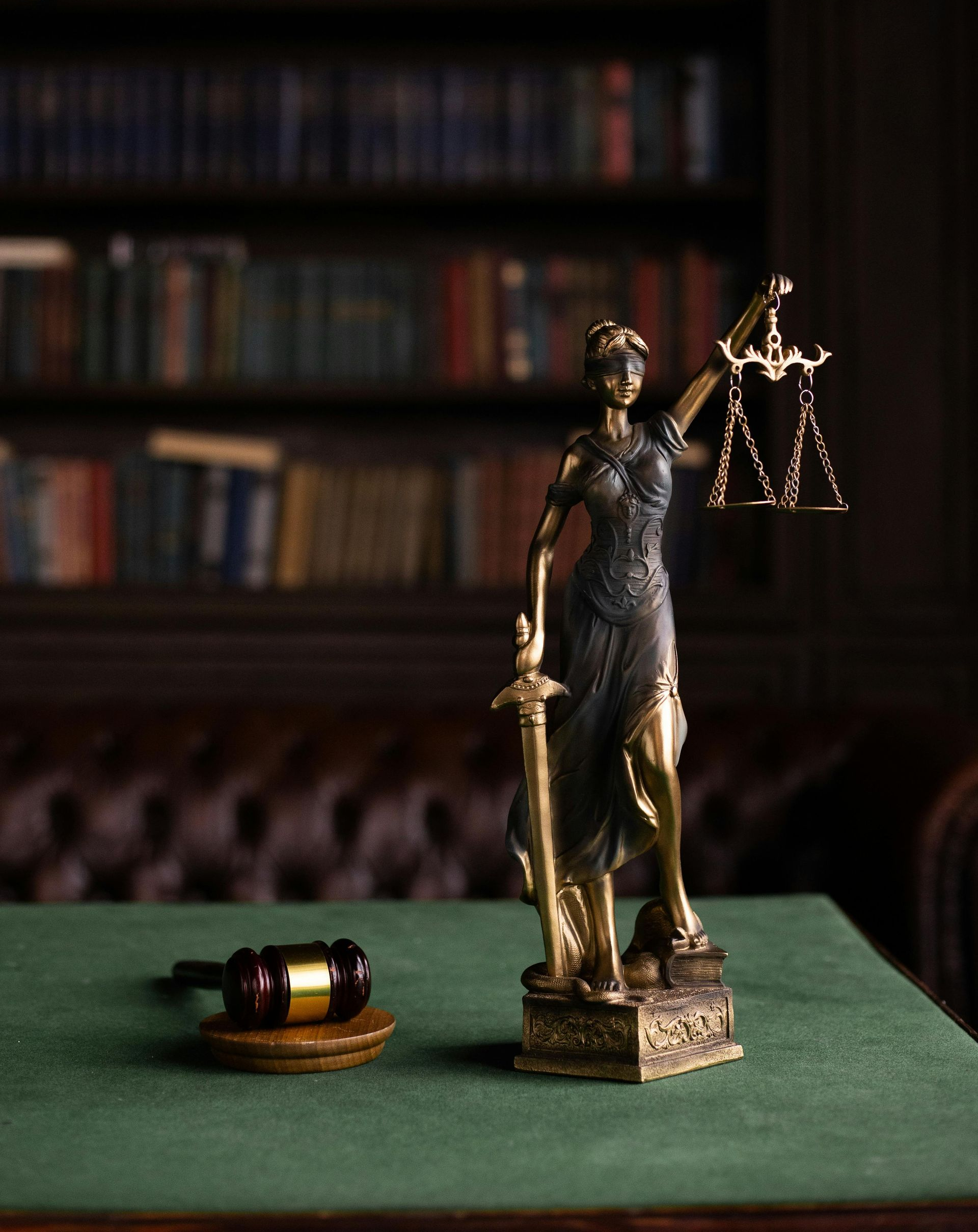 Two men in suits, discussing documents at a table. One gestures, the other listens intently.