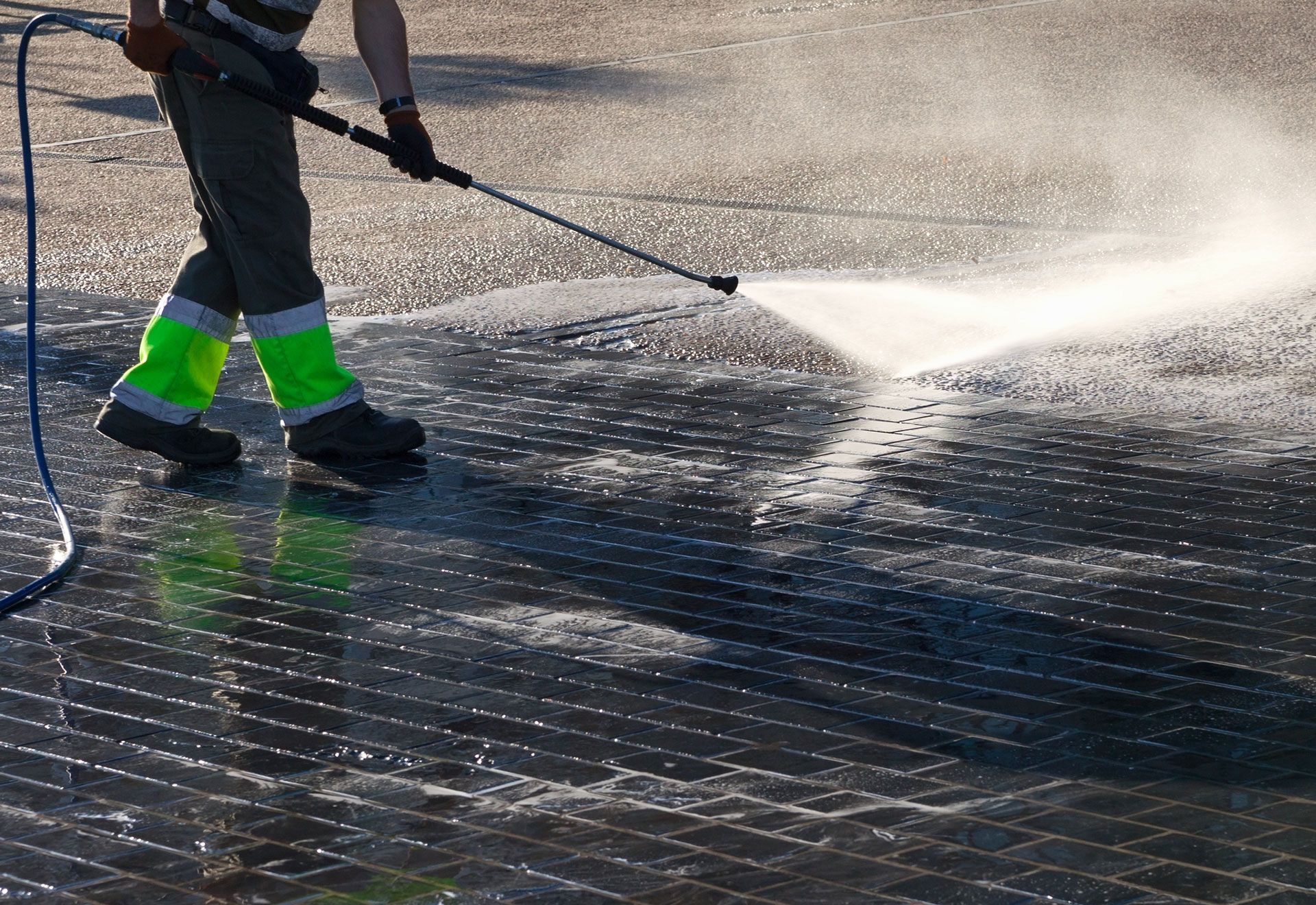 A man is using a high pressure washer.