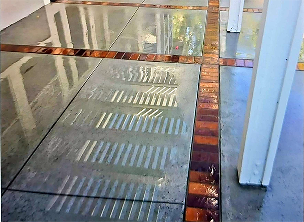 A reflection of a building in a glass floor