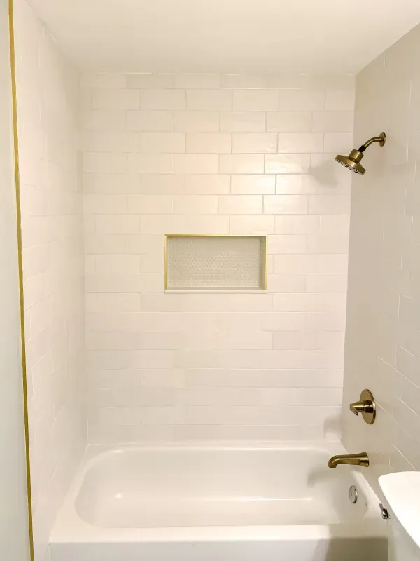 A bathroom with a bathtub and a shower.