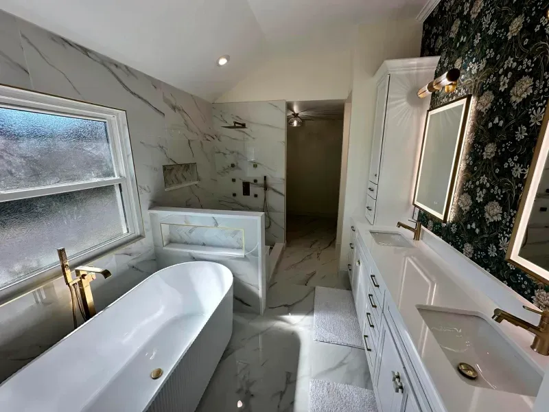 A bathroom with a bathtub , sink , and shower.