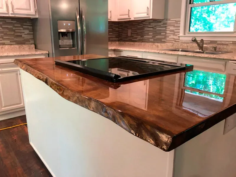 A kitchen with a wooden counter top and a stove top oven.