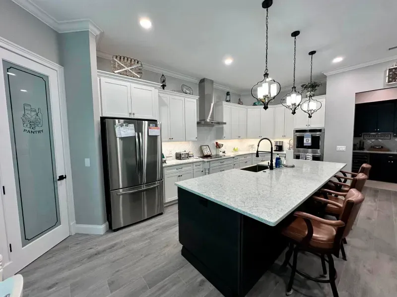 There is a large island in the middle of the kitchen.
