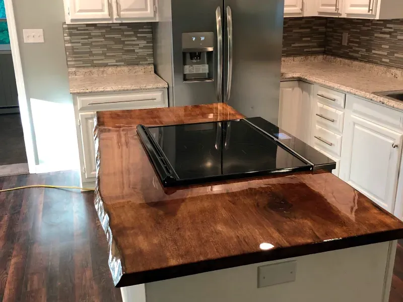 A kitchen with a wooden counter top and a stove top oven.