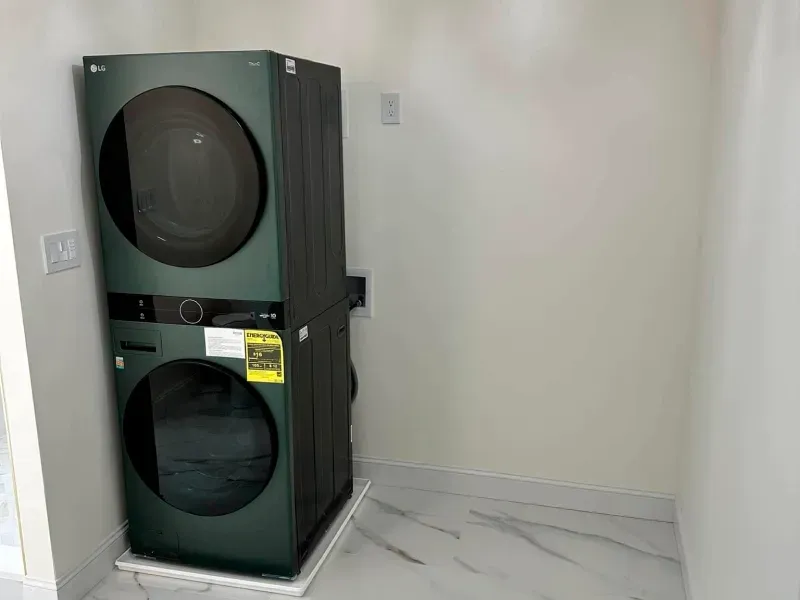A stacked washer and dryer in a laundry room.