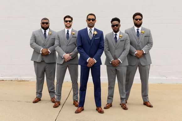 men in blue and gray tuxedos