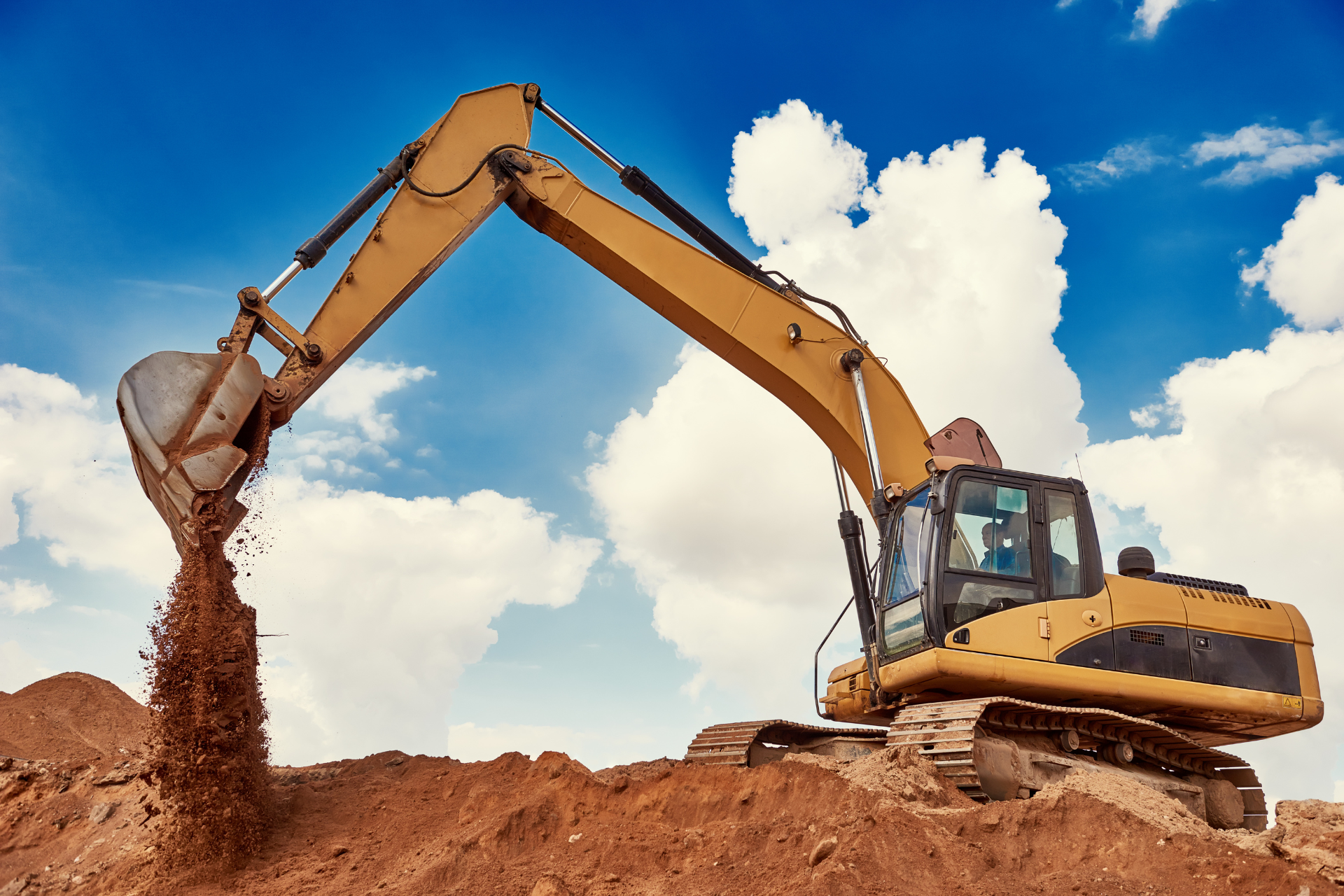 A large excavator is digging a hole in the dirt.