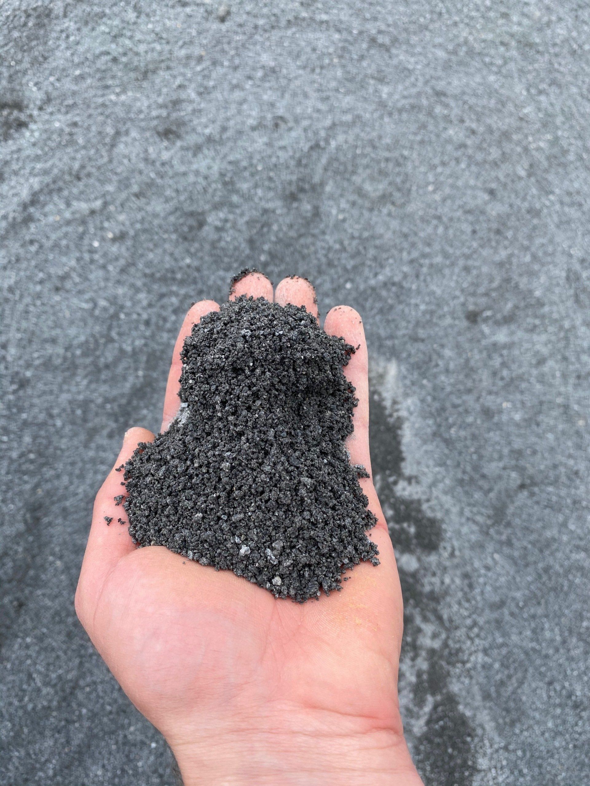 Black Sand in hand showing fineness