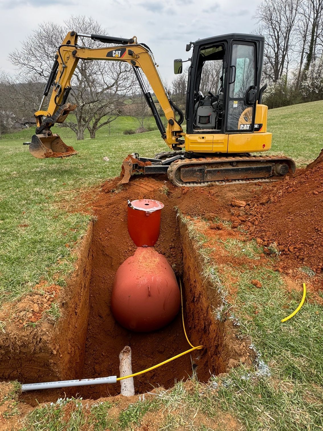 Propane tank being installed into propane trench that was recently excavated