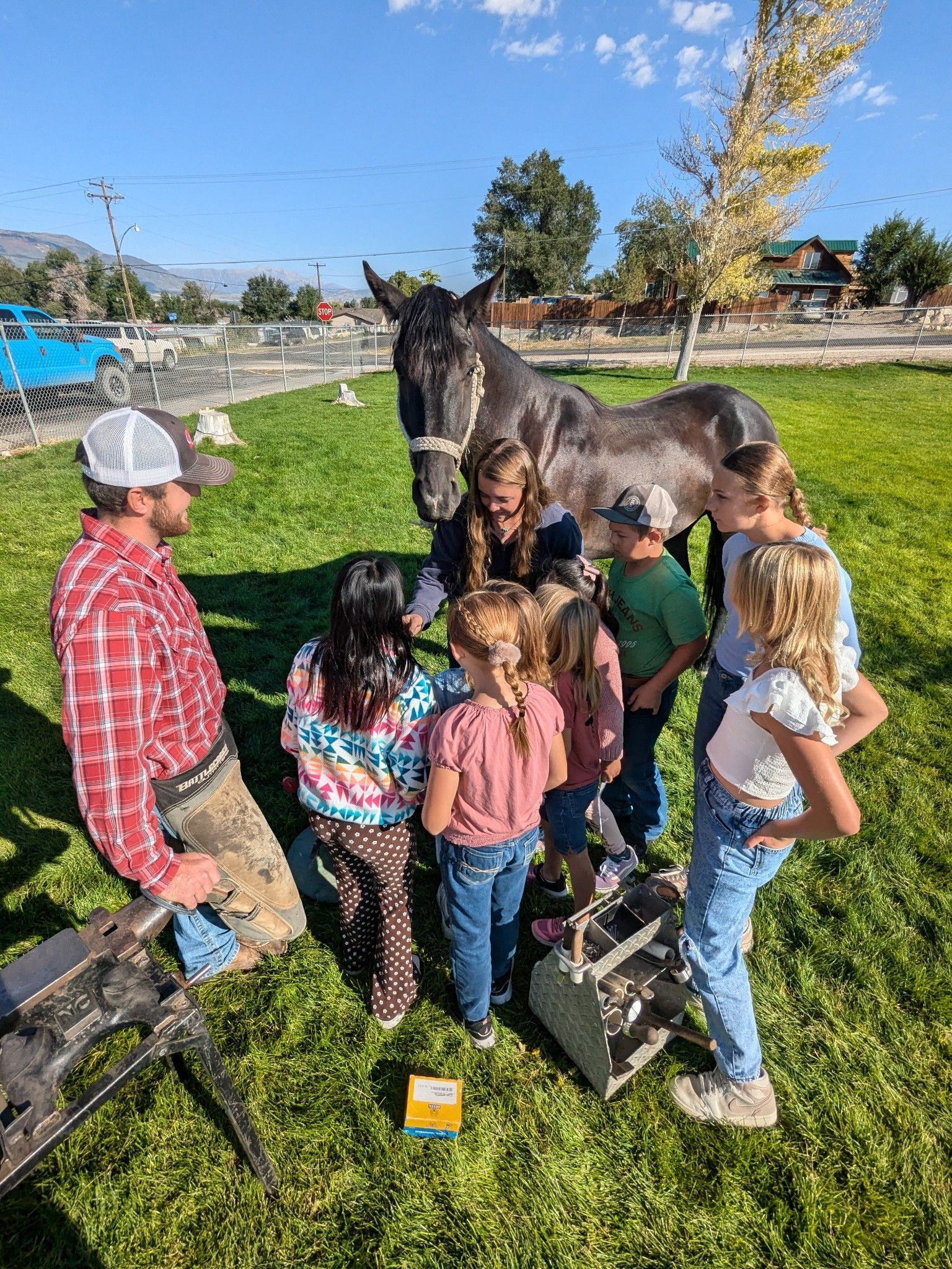 A group of students petting a horse.