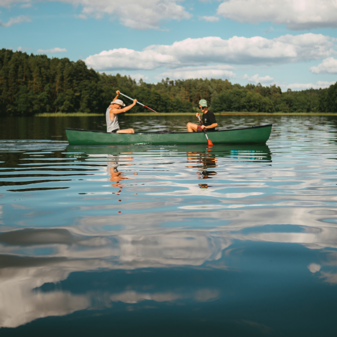 Two people are paddling a canoe on a lake.
