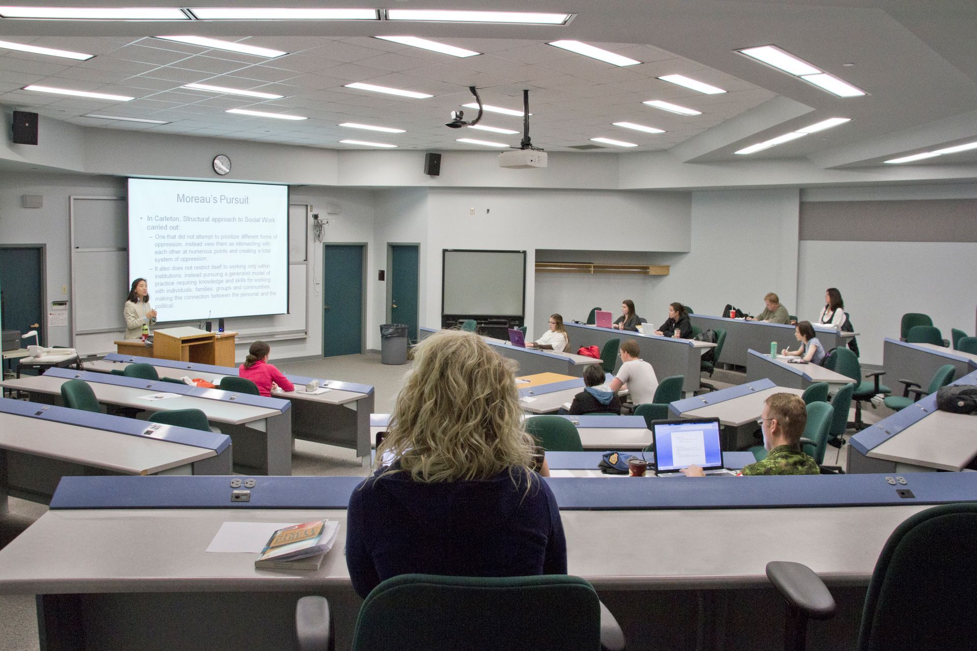 A large room with a lot of windows and a wooden ceiling