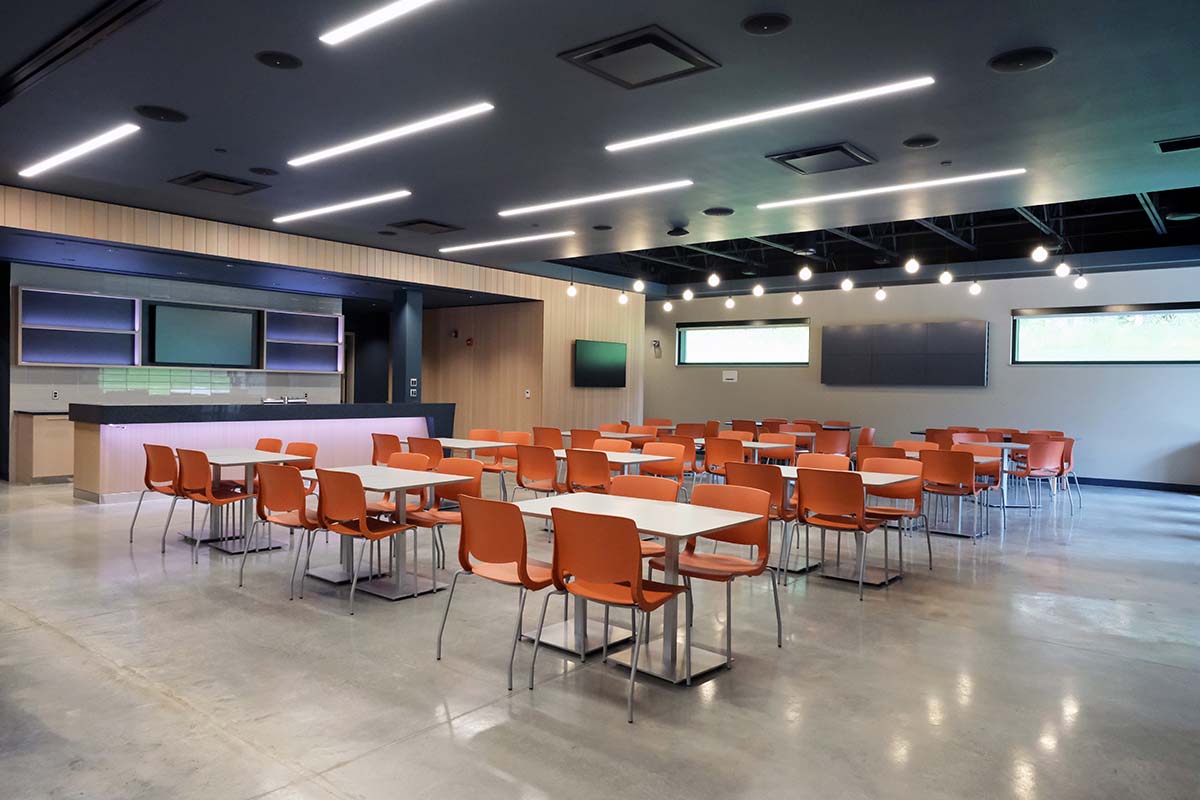 A large room with tables and chairs in it.