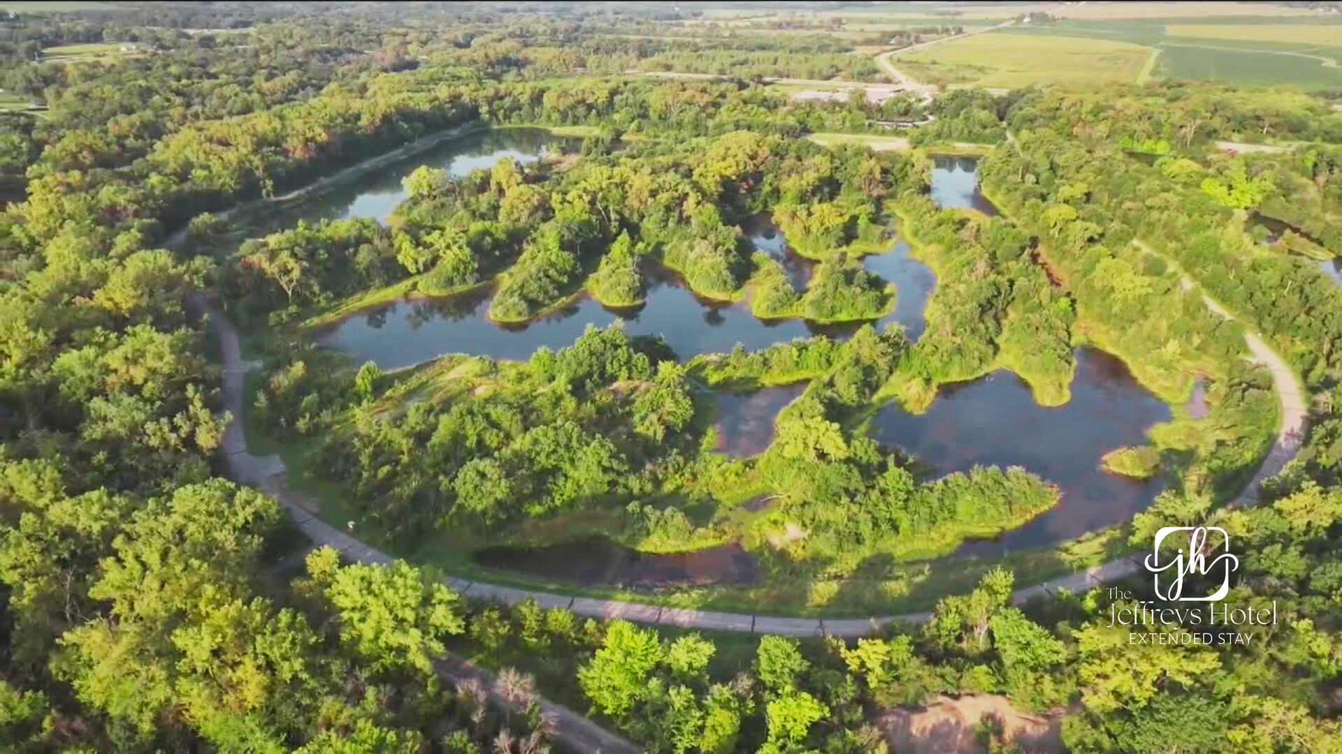 Aerial view of Banner Lakes and Summerset Trail surrounded by green trees and a walking path.