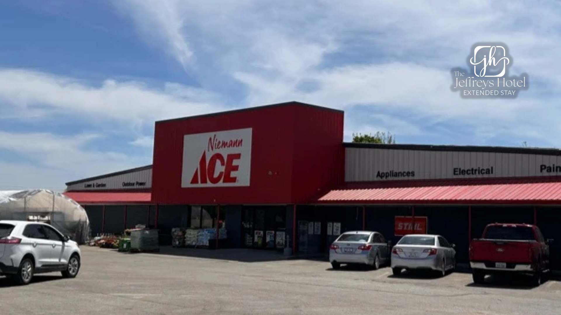 Exterior of a red-fronted ACE Hardware store in Osceola with parked cars on a sunny day.