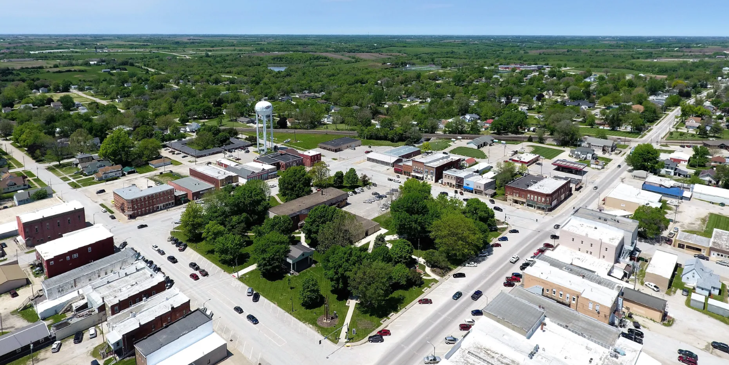 Aerial view of downtown Osceola, Iowa featuring historic buildings, tree-lined streets, the Clarke County Courthouse Square