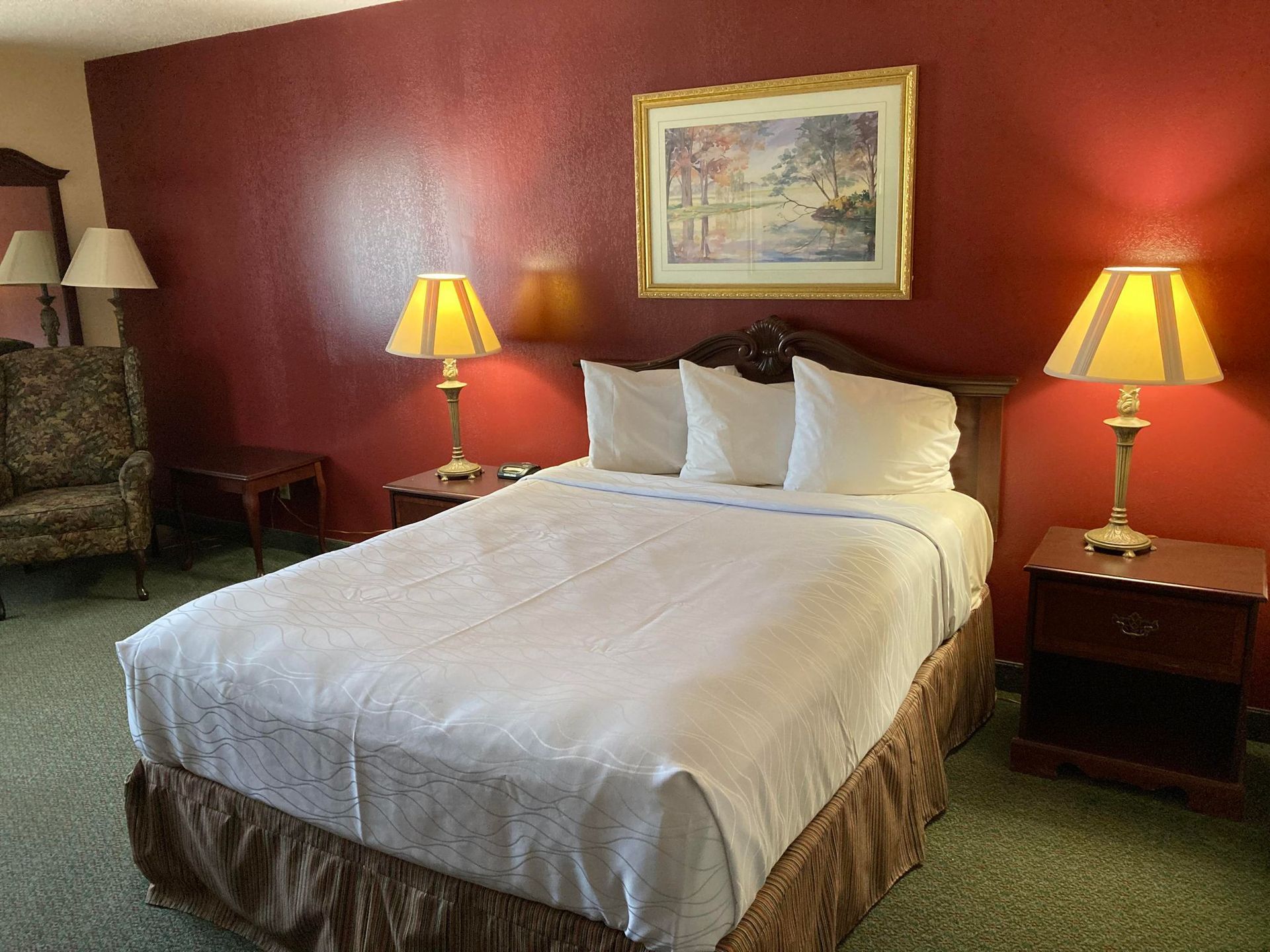 Cozy queen room with warm decor and comfortable bedding at The Jeffreys Hotel, perfect for weekly stays and traveling couples