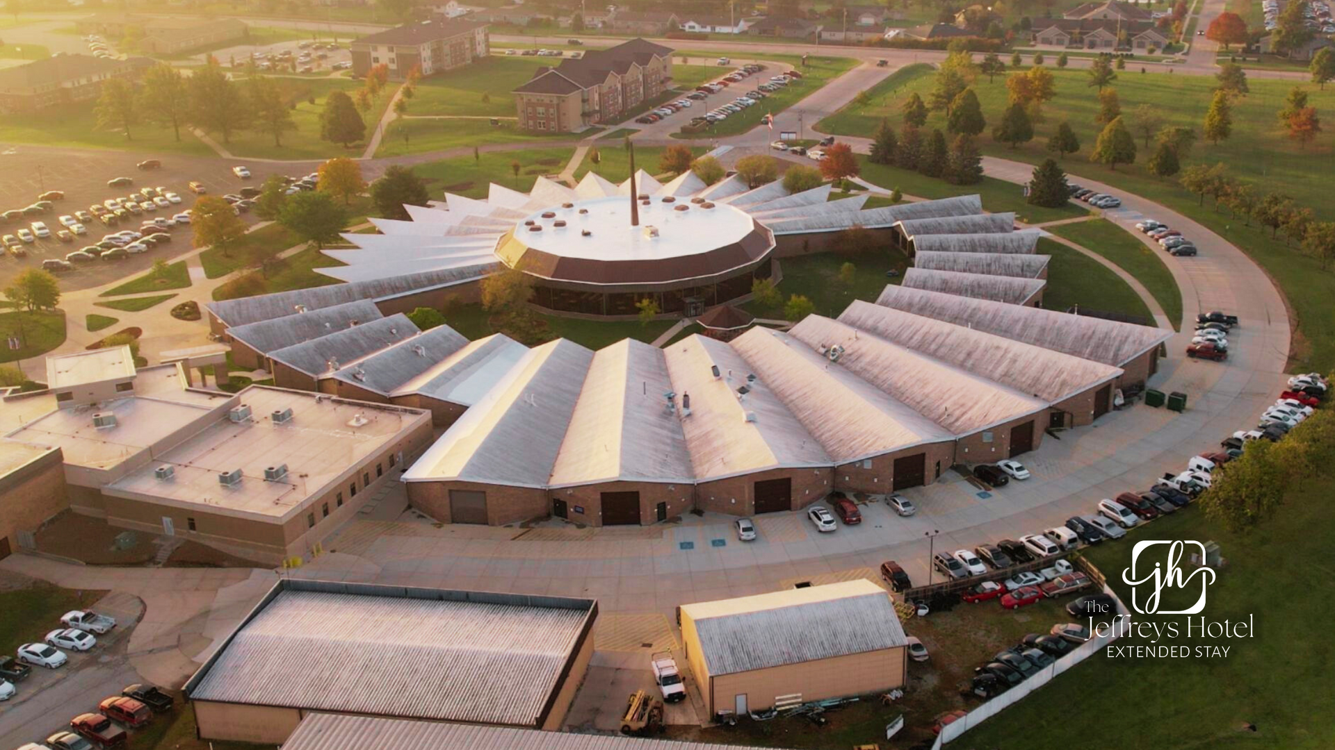 SWCC campus. A domed center building, surrounded by angled roof sections, cars, and trees.