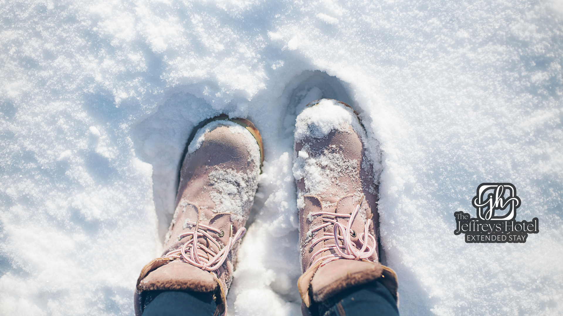 Pink boots in snow, leaving footprints on an Osceola, Iowa town square stroll.