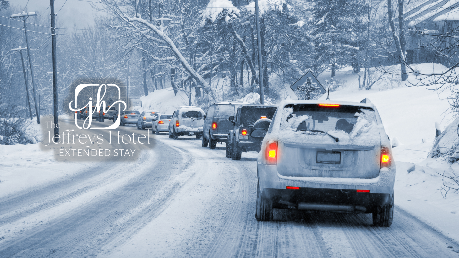 Cars stuck in traffic on a snowy road with snow-covered trees during a winter storm in Osceola, Iowa