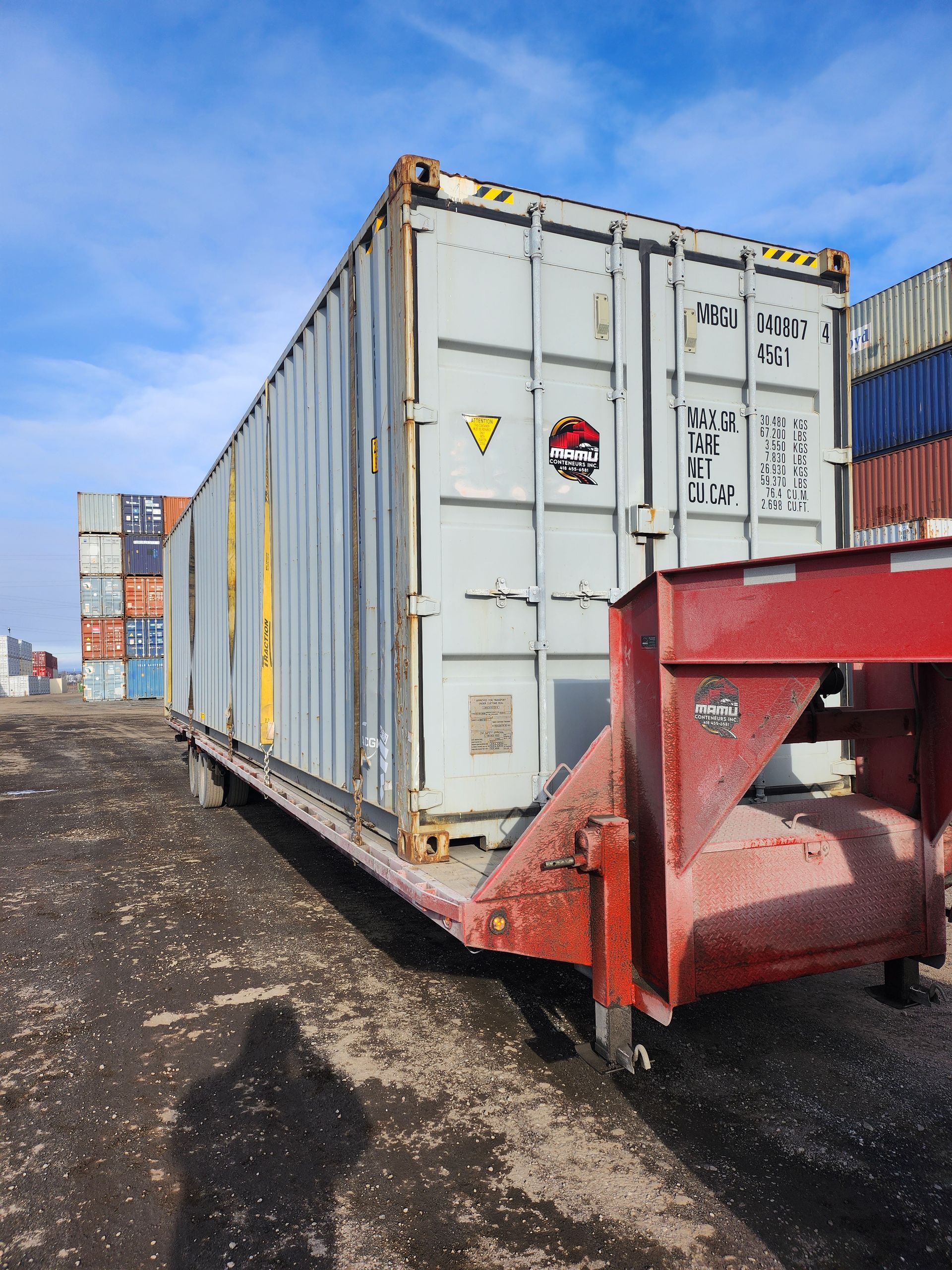 Un grand conteneur d'expédition est posé sur une remorque