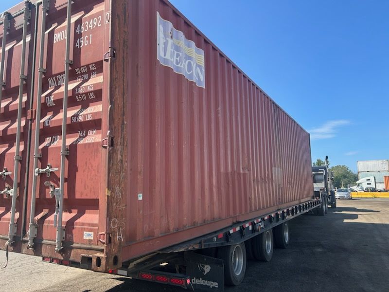 Un conteneur d'expédition rouge avec le mot Leon dessus