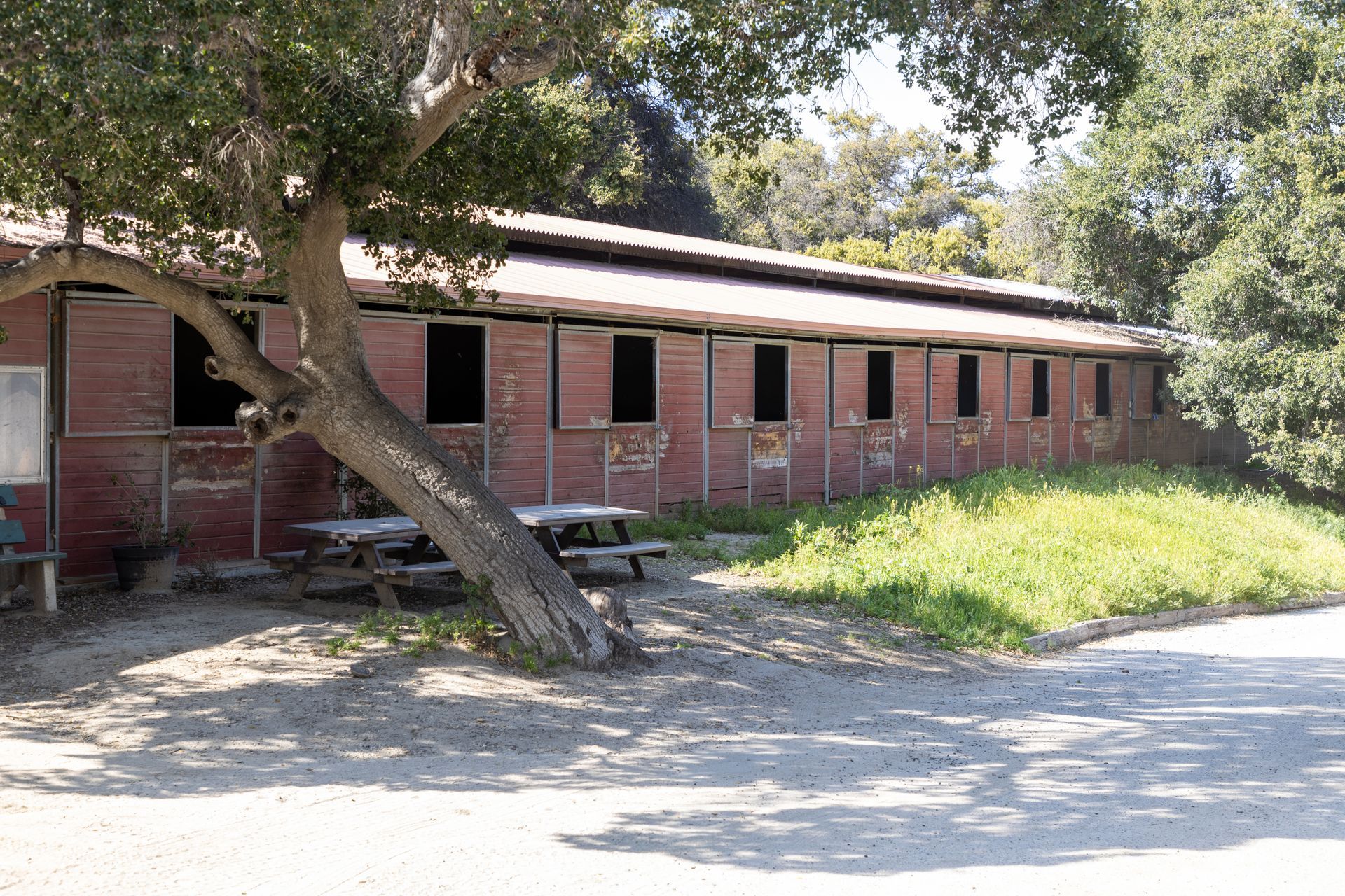 A brick building with a picnic table in front of it.
