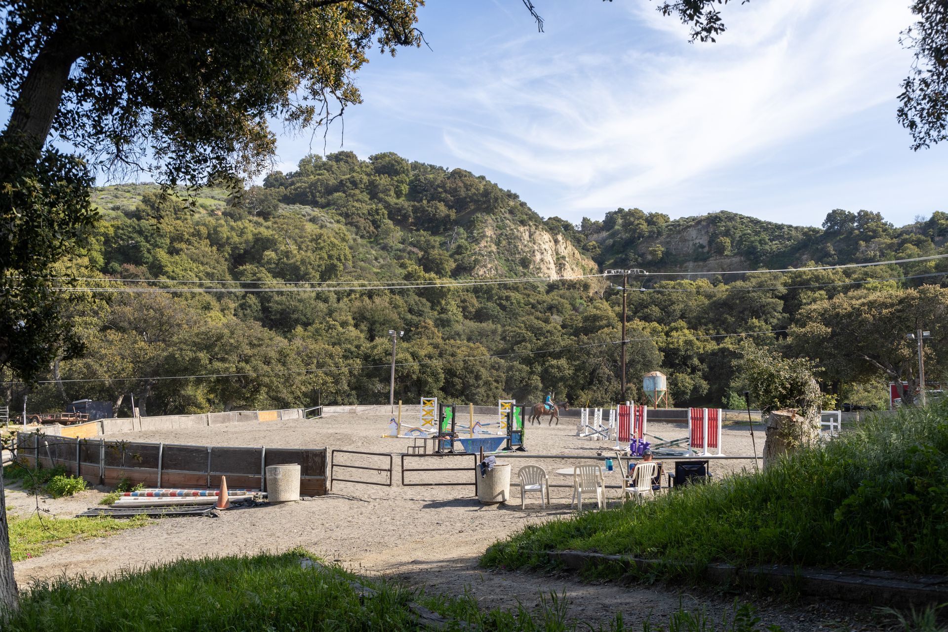 A view of a fenced in area with trees in the background