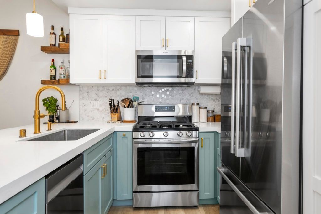 a kitchen with stainless steel appliances and blue cabinets