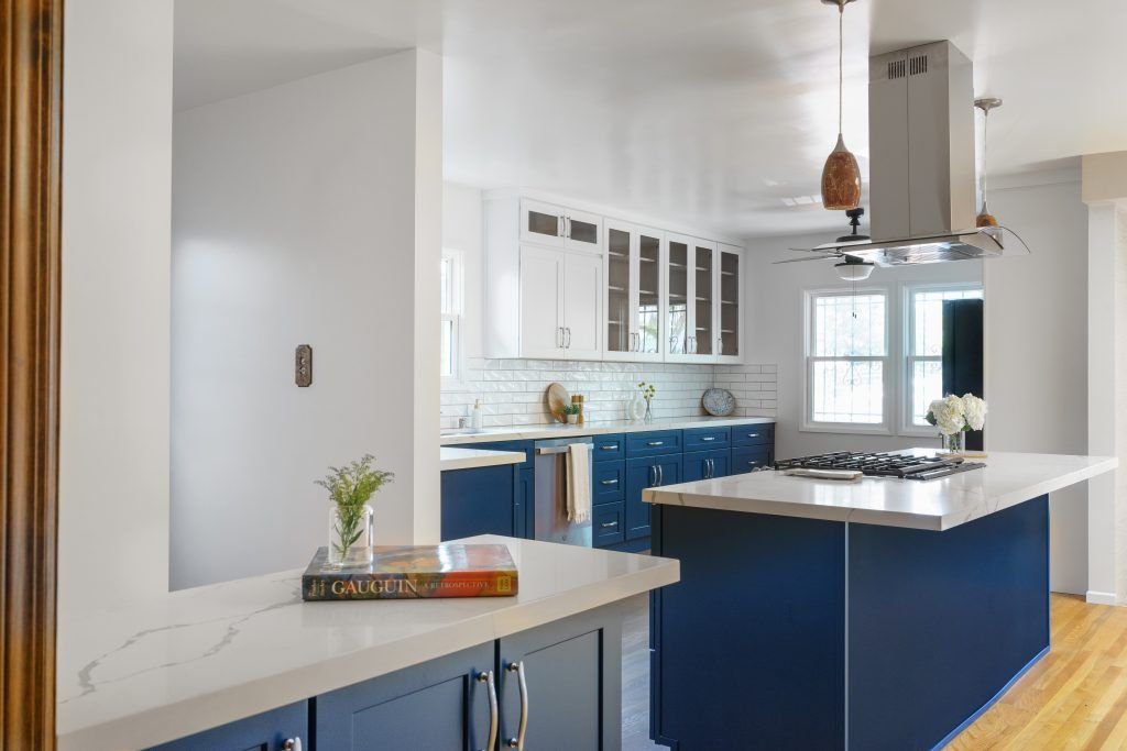 a kitchen with blue cabinets and a book on the counter .