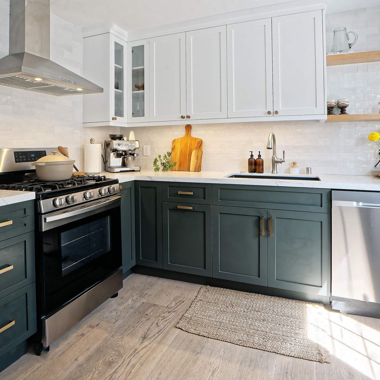 a kitchen with stainless steel appliances and green cabinets