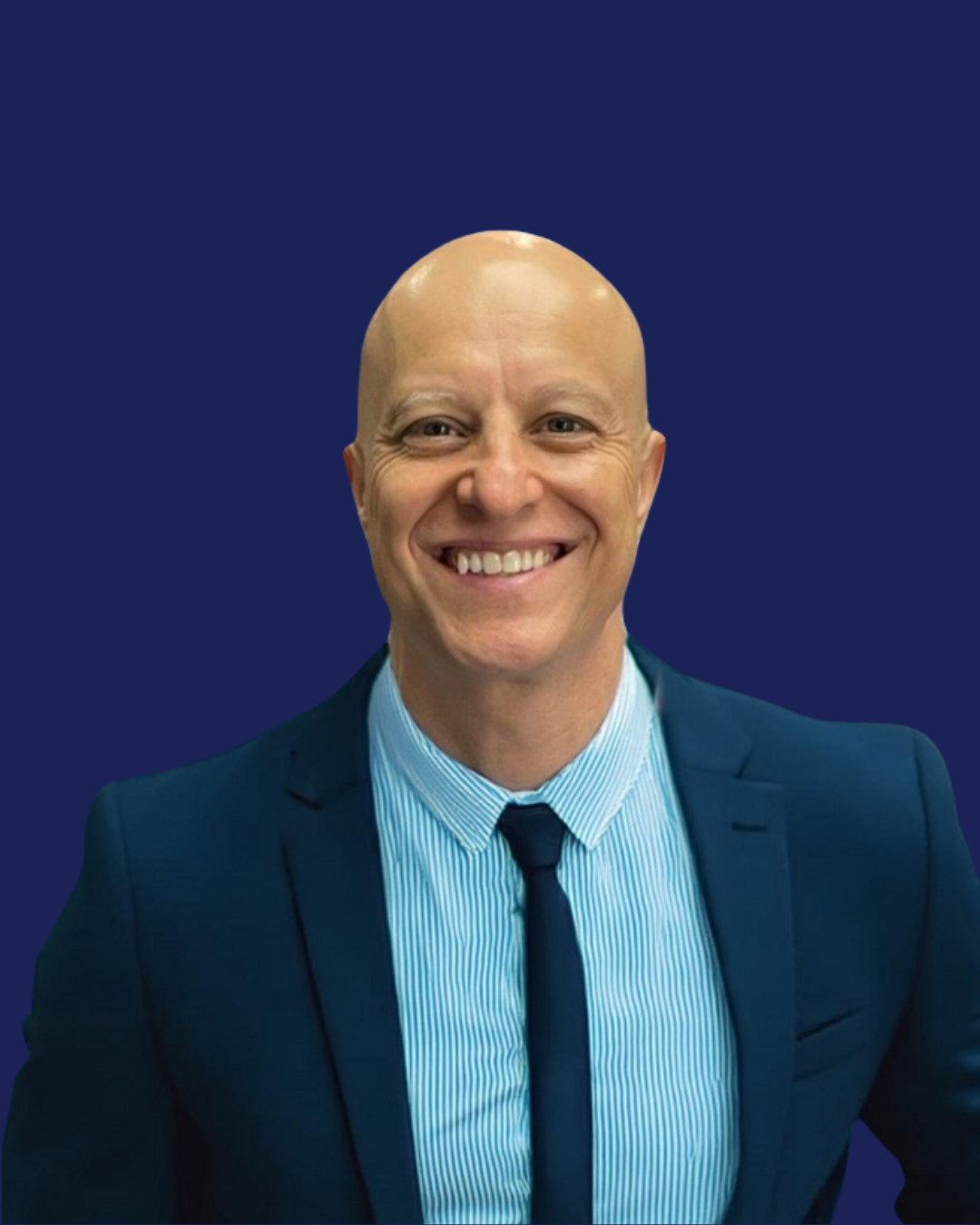 A woman is sitting at a desk with a laptop and a vase of flowers.