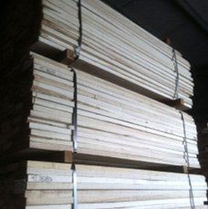 A pile of wood is stacked on top of each other in a warehouse.