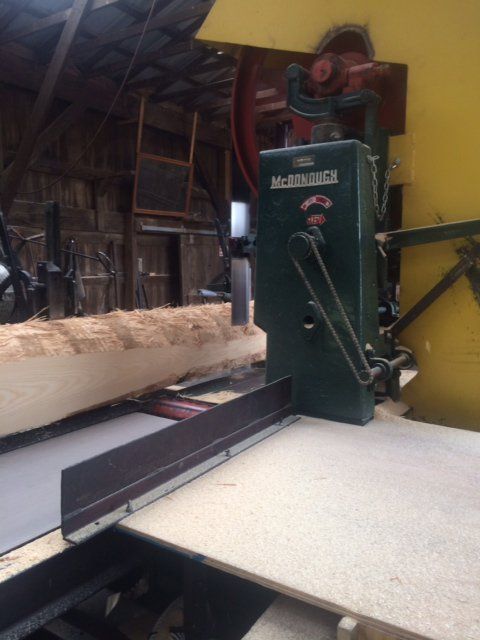 A large piece of wood is being cut by a machine that says ' albrecht ' on it
