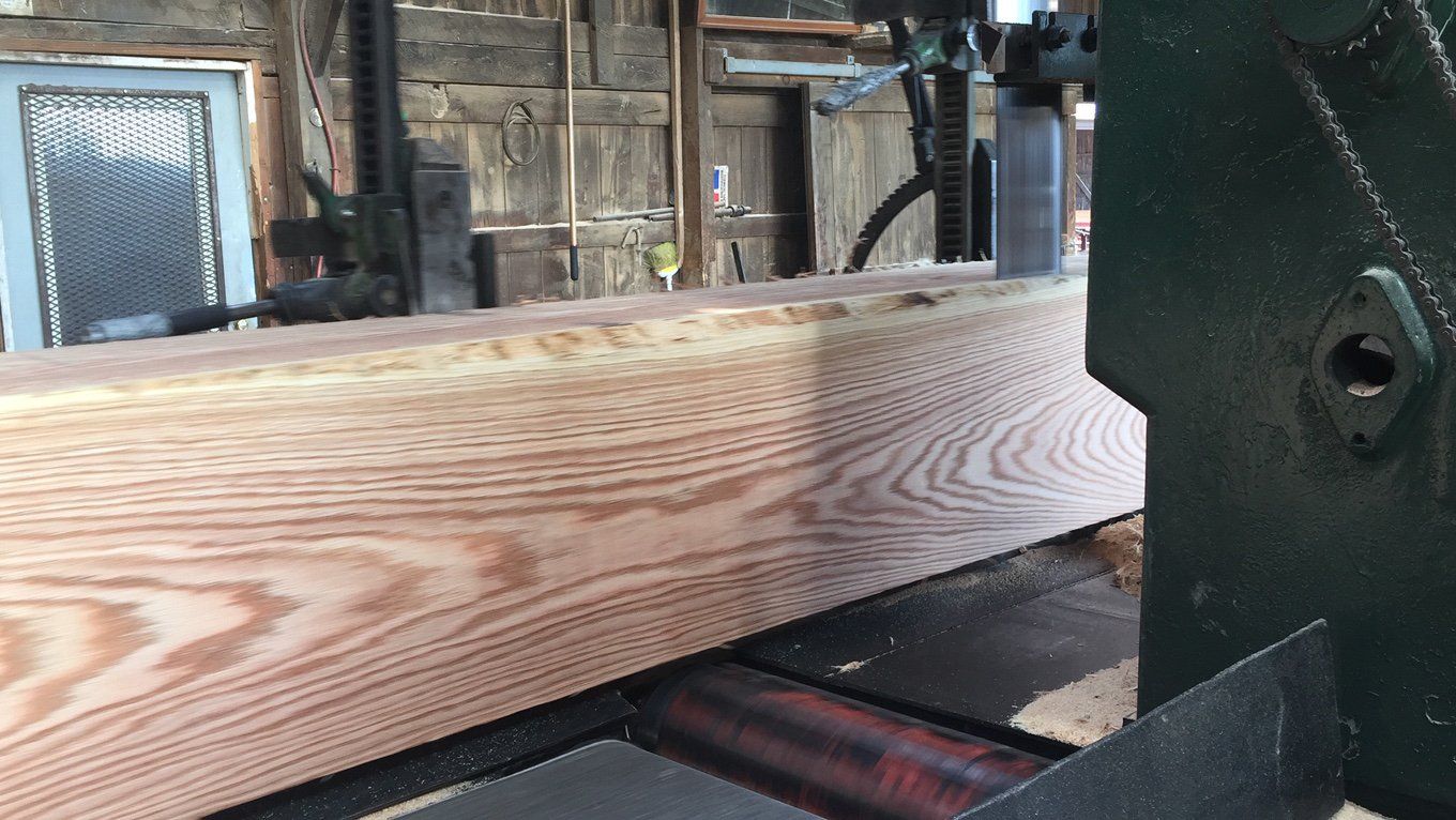 A piece of wood is being cut on a machine.